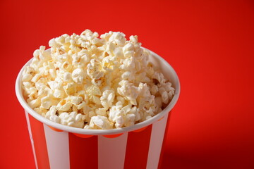 Buckets with delicious popcorn on red background 