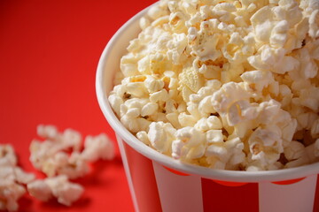 Buckets with delicious popcorn on red background 