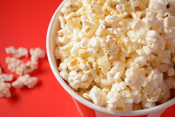 Buckets with delicious popcorn on red background 