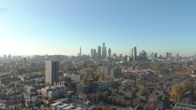 dolly forward drone shot from residential London looking towards the financial centre of the capital