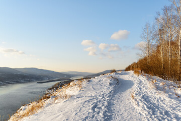 Fototapeta na wymiar The Yenisey River among scenic mountains covered with snow