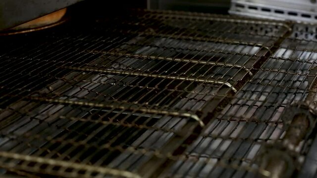 the finished pizza rolls out of the oven