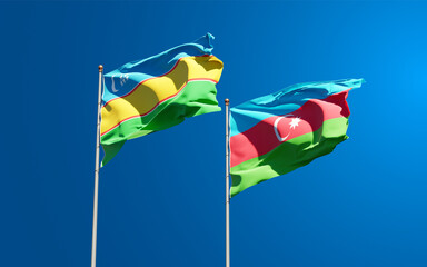 Beautiful national state flags of Karakalpakstan and Azerbaijan together at the sky background. 3D artwork concept.