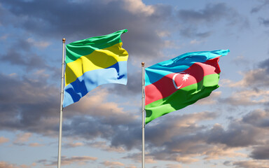 Beautiful national state flags of Gabon and Azerbaijan together at the sky background. 3D artwork concept.