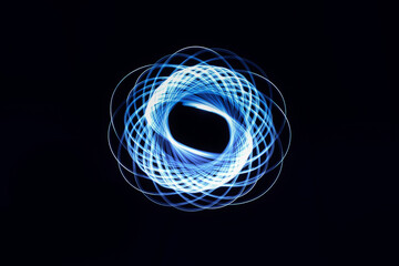 2020-11-07 ABSTRACT CIRCULAR LIGHT STREAKS WITH A BLUE TINT AND BLACK BACKGROUND