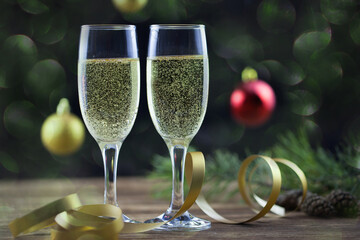 Christmas background, champagne glasses on a wooden surface