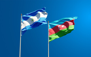 Beautiful national state flags of Nicaragua and Azerbaijan together at the sky background. 3D artwork concept.