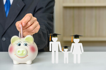Saving money for child education, financial concept : Donor put money in a piggybank or donation...