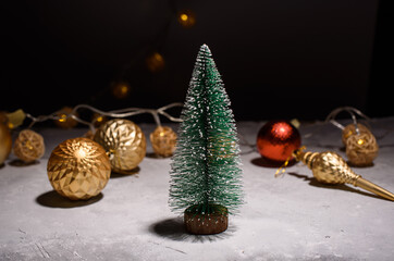 Naklejka na ściany i meble New Year's card on a bright background. Little eve tree, Christmas tree balls, lights . Merry christmas and happy new year