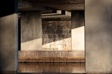 Fototapeta na wymiar Concrete columns of a bridge over a lake 