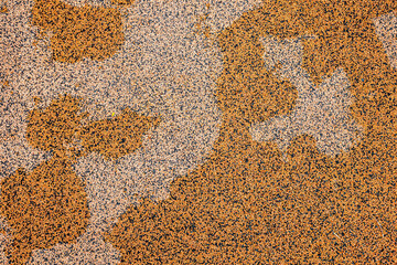 close up of orange bouncy floor in child's playground, with drying water.