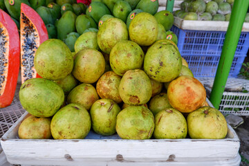 Arrangement of guava fruit in a basket at a traditional fruit shop in Yogyakarta