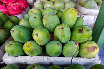 Arranged mango fruit in a basket at a traditional fruit shop in Yogyakarta