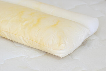 Pillow with yellow saliva stains