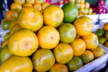 A close-up of an arrangement of mandarin oranges at a traditional fruit shop in Indonesia