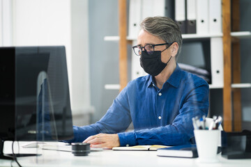 Employee In Office Social Distancing Using Sneeze Guard