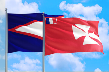 Wallis And Futuna and American Samoa national flag waving in the windy deep blue sky. Diplomacy and international relations concept.