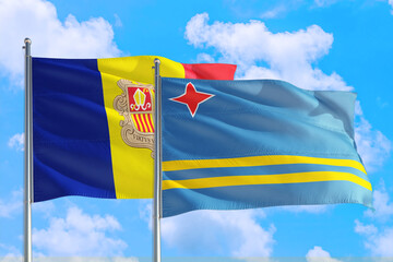 Aruba and Andorra national flag waving in the windy deep blue sky. Diplomacy and international relations concept.