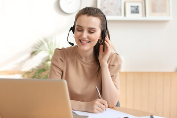 Freelance operator talking with headsets and consulting clients from home office.