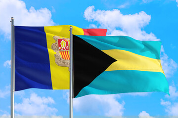 Bahamas and Andorra national flag waving in the windy deep blue sky. Diplomacy and international relations concept.
