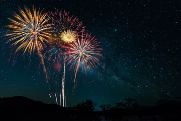 Foto op Canvas Colorful of fireworks display on milkyway in night sky background. © Meawstory15Studio