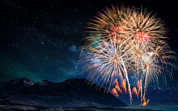 Colorful of fireworks display on milkyway in night sky background.