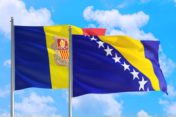 Bosnia Herzegovina and Andorra national flag waving in the windy deep blue sky. Diplomacy and international relations concept.