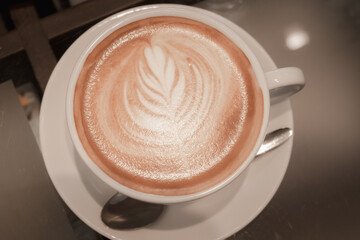 Hot latte coffee in white cup on a table in coffee shop .top view.flat lay.top down.close up.