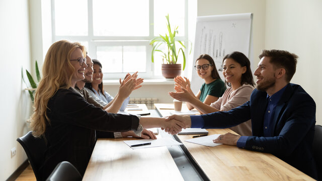 Congratulate you on promotion. Middle aged lady boss ceo shaking hand of happy millennial manager worker greeting with professional career growth, senior woman team leader welcoming new male employee