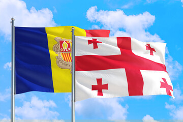 Georgia and Andorra national flag waving in the windy deep blue sky. Diplomacy and international relations concept.