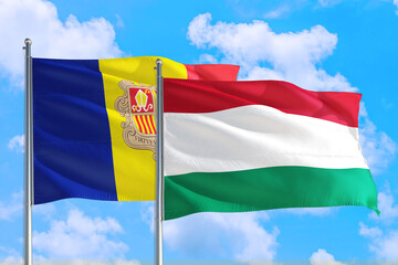 Hungary and Andorra national flag waving in the windy deep blue sky. Diplomacy and international relations concept.