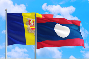 Laos and Andorra national flag waving in the windy deep blue sky. Diplomacy and international relations concept.