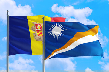 Marshall Islands and Andorra national flag waving in the windy deep blue sky. Diplomacy and...
