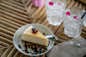 Cheese cake on white plate at wooden table