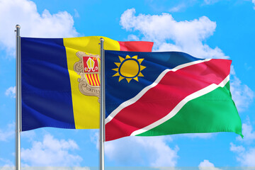 Namibia and Andorra national flag waving in the windy deep blue sky. Diplomacy and international relations concept.