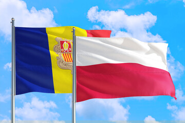 Poland and Andorra national flag waving in the windy deep blue sky. Diplomacy and international relations concept.