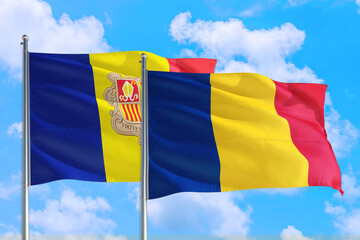 Romania and Andorra national flag waving in the windy deep blue sky. Diplomacy and international relations concept.