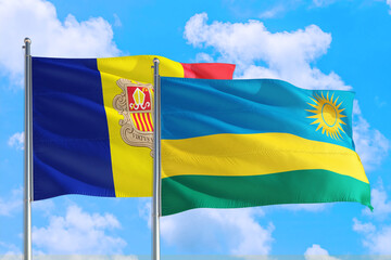 Rwanda and Andorra national flag waving in the windy deep blue sky. Diplomacy and international relations concept.
