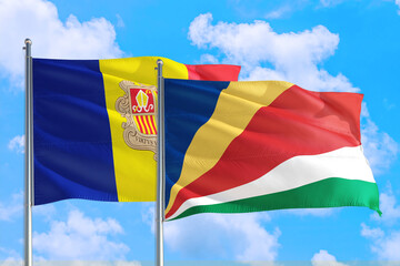 Seychelles and Andorra national flag waving in the windy deep blue sky. Diplomacy and international relations concept.