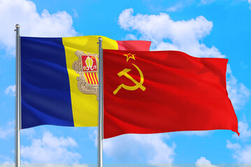 Soviet Union and Andorra national flag waving in the windy deep blue sky. Diplomacy and international relations concept.