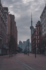 The street view of Shanghai's bund at sunrise, on a cloudy day.