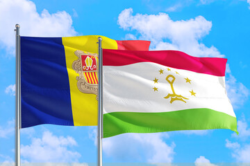 Tajikistan and Andorra national flag waving in the windy deep blue sky. Diplomacy and international relations concept.