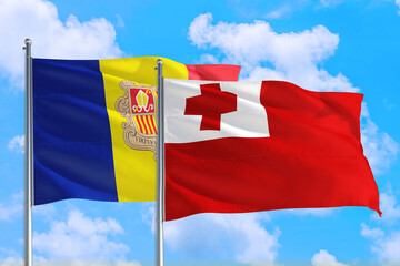 Tonga and Andorra national flag waving in the windy deep blue sky. Diplomacy and international relations concept.