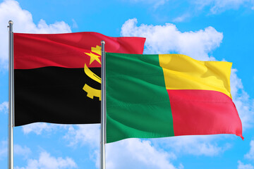 Benin and Angola national flag waving in the windy deep blue sky. Diplomacy and international relations concept.