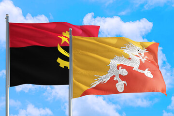 Bhutan and Angola national flag waving in the windy deep blue sky. Diplomacy and international relations concept.