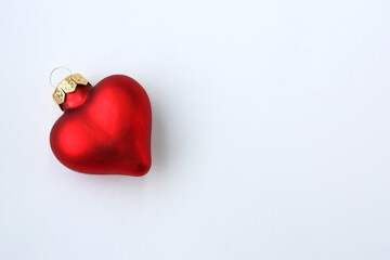 Christmas toy in the form of a heart on a white background. There is room for text.