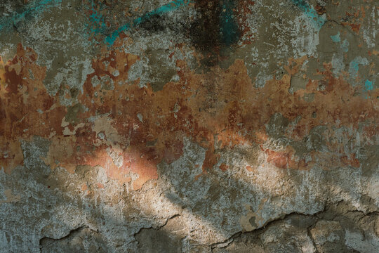 Old stone wall with peeling plaster, dark background for design, social networks. Polymest with settling paint and plaster, space for text
