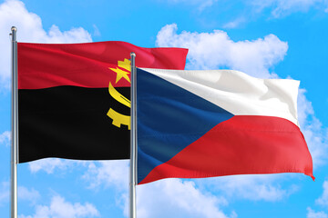 Czech Republic and Angola national flag waving in the windy deep blue sky. Diplomacy and international relations concept.