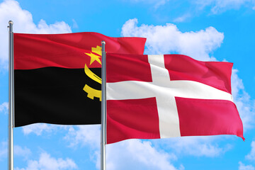 Denmark and Angola national flag waving in the windy deep blue sky. Diplomacy and international relations concept.