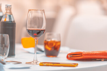 Glass of Red Wine on the food table with Lights Bokeh at night background.